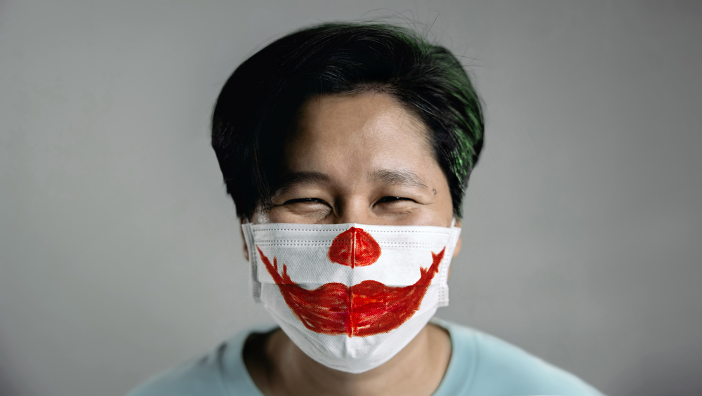 Man with a decorated face mask.