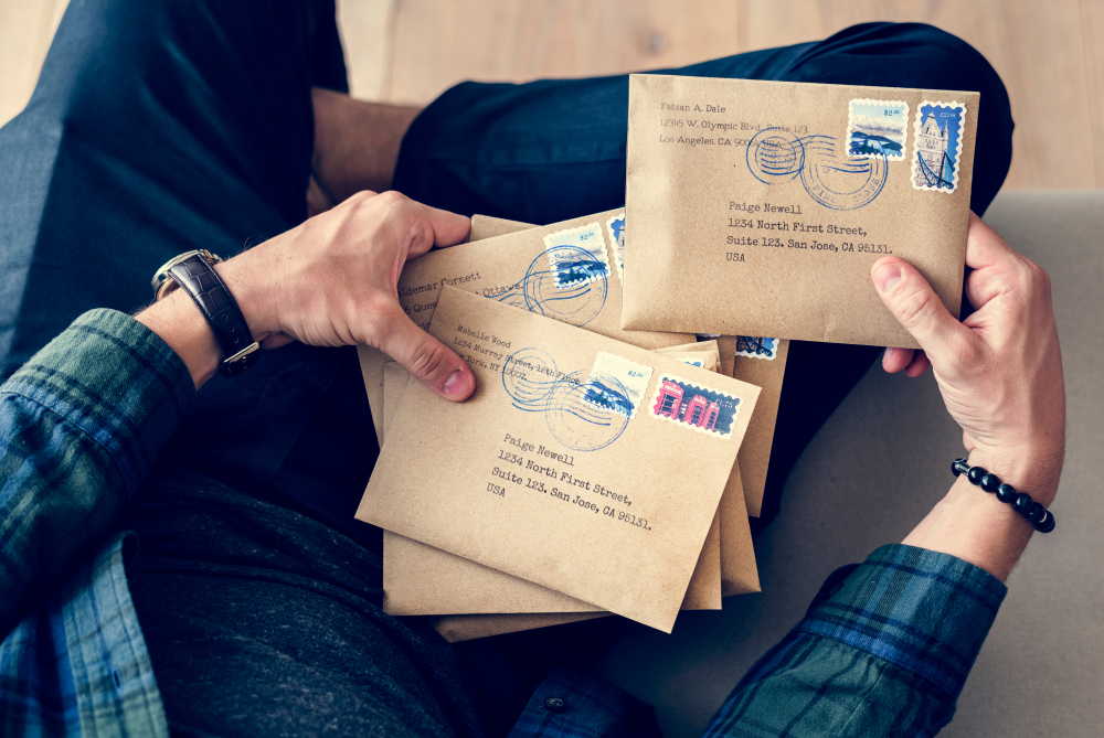 Man holding letters.